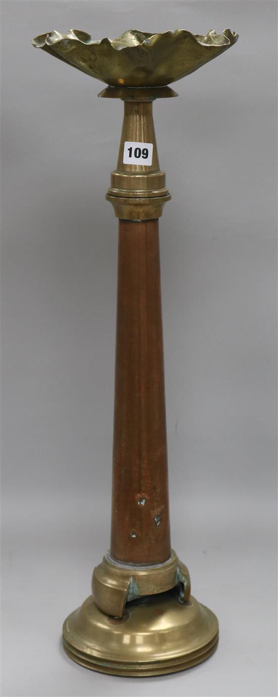 A brass and copper ashtray with fire nozzle stem